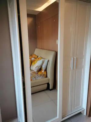 a bedroom with a bed in a closet with a mirror at SHELL RESIDENCES MOA COMPLEX PASAY in Manila