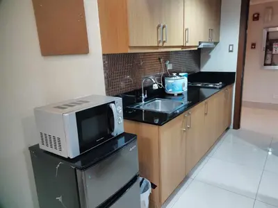 a kitchen with a microwave and a sink at SHELL RESIDENCES MOA COMPLEX PASAY in Manila