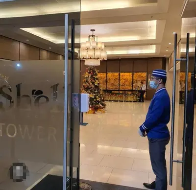 a man wearing a mask standing in a store window at SHELL RESIDENCES MOA COMPLEX PASAY in Manila