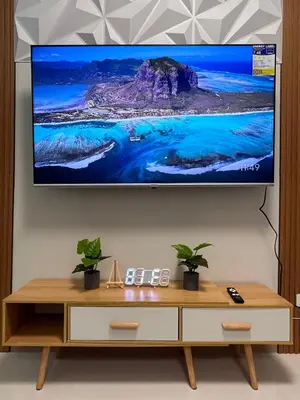 a flat screen tv hanging on a wall at Molly Shore Getaway Unit 1241 in Manila