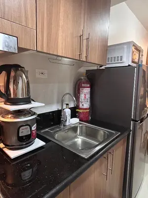 a kitchen with a sink and a microwave at Molly Shore Getaway Unit 1241 in Manila