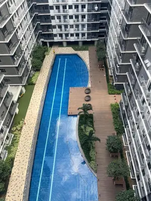an overhead view of a swimming pool between two apartment buildings at Molly Shore Getaway Unit 1241 in Manila