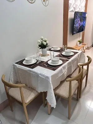 a dining room table with a white table cloth on it at Molly Shore Getaway Unit 1241 in Manila