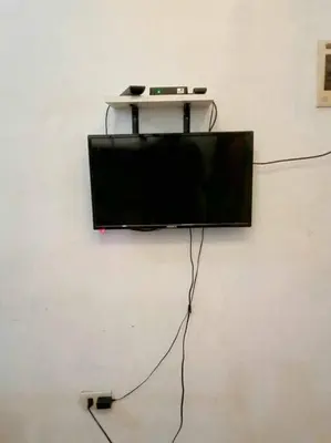 a flat screen tv hanging on a wall at Matthew's Private Pool by Mia and Miguel's House in General Trias