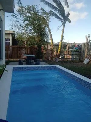 a large blue swimming pool in a yard at Matthew's Private Pool by Mia and Miguel's House in General Trias