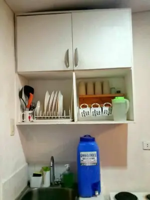 a kitchen counter with a sink with a blue bottle at Matthew's Private Pool by Mia and Miguel's House in General Trias