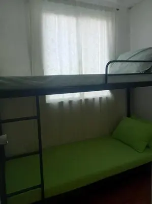 a green bunk bed in a room with a window at Matthew's Private Pool by Mia and Miguel's House in General Trias