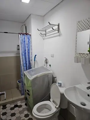 a bathroom with a toilet and a sink at Athena's Place - Hope Residences SMDC Trece Cavite in Trece Martires