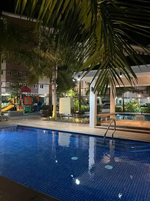 a large swimming pool in a building with a resort at Athena's Place - Hope Residences SMDC Trece Cavite in Trece Martires