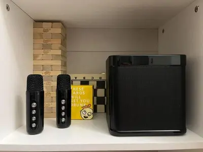 two remote controls sitting on a shelf next to a microwave at Athena's Place - Hope Residences SMDC Trece Cavite in Trece Martires