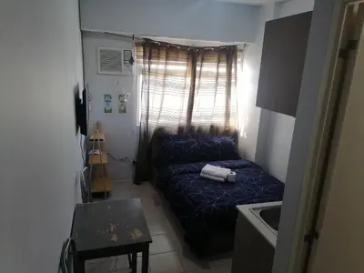 a small room with a blue bed in a room at Para Sa'yo in Manila