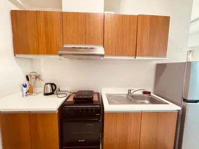 a small kitchen with a stove and a sink at 1 Bedroom Homestay in 8 Adriatico Manila in Manila