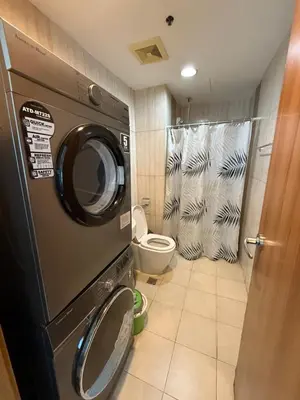 a washing machine in a bathroom with a toilet at 1 Bedroom Homestay in 8 Adriatico Manila in Manila