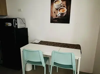 a table with two chairs and two cups of coffee at Shore Residence D23 shortwalk MOA in Manila