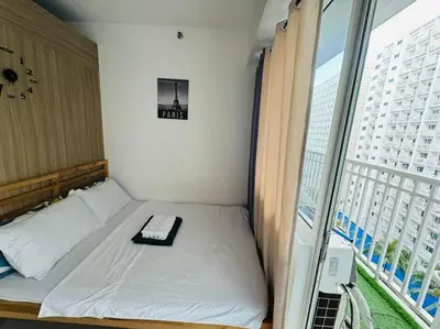a small bed in a room with a window at Shore Residence D23 shortwalk MOA in Manila