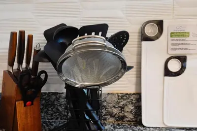 a mortar and pestle on a counter next to knives at Makati Altean Apartment (Delfin Room) in Manila