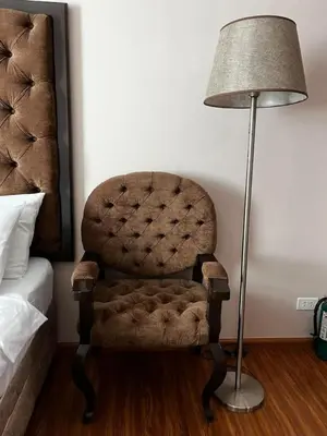 a bedroom with a chair next to a lamp at The Beacon Condo (1BR Unit) in Manila