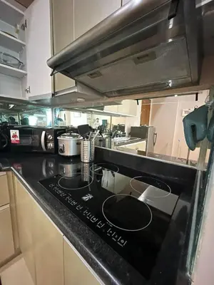 a kitchen with a black counter top in a kitchen at The Beacon Condo (1BR Unit) in Manila