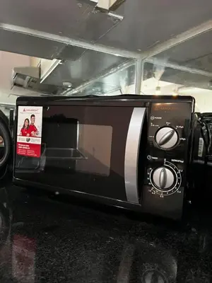 a microwave oven with a picture of a couple at The Beacon Condo (1BR Unit) in Manila
