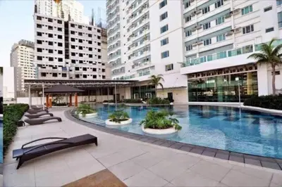 a large swimming pool in the middle of a building at The Beacon Condo - Studio Tower 1 in Manila