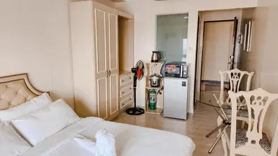 a living room with a white couch and a refrigerator at The Beacon Condo - Studio Tower 1 in Manila