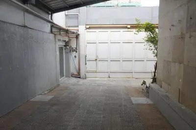an empty parking lot with a white garage door at Makati Altean Apartment (Maura Room) in Manila