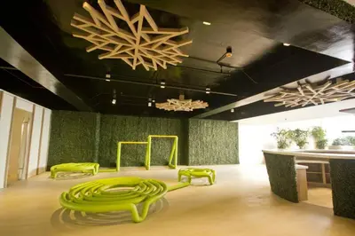 a room with green chairs and a chandelier at KL Tower Condo, Makati City in Manila