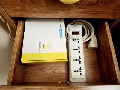 a remote control in a wooden drawer with a box at KL Tower Condo, Makati City in Manila