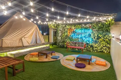 a room with a tent and tables and a bench at Maria Deck Urban Glamping in Manila