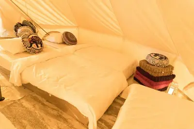 a small room with a bed in a tent at Maria Deck Urban Glamping in Manila