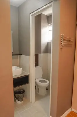 a bathroom with a toilet and a sink at ALTEAN Apartments - Isabela Room in Manila