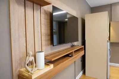 a room with a mirror and a tv on a wall at ALTEAN Apartments - Isabela Room in Manila