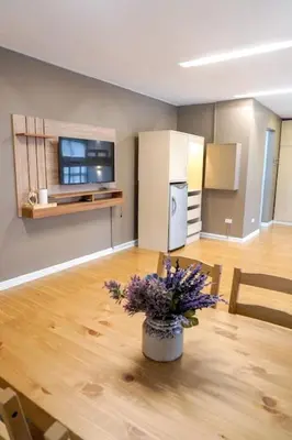 a living room with a table with flowers on it at ALTEAN Apartments - Isabela Room in Manila