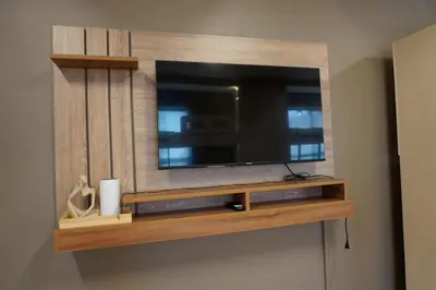 a entertainment center with a television on a wall at ALTEAN Apartments - Isabela Room in Manila