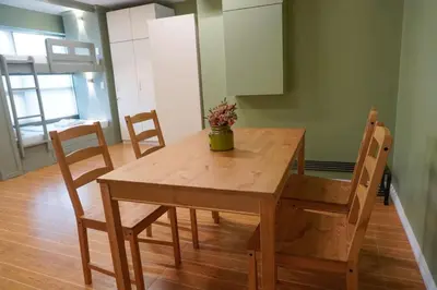 a wooden table and chairs in a room at ALTEAN Apartments - Lourdes Room in Manila
