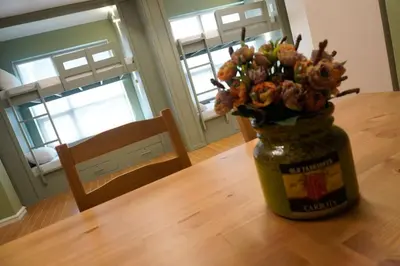 a jar filled with flowers sitting on a table at ALTEAN Apartments - Lourdes Room in Manila