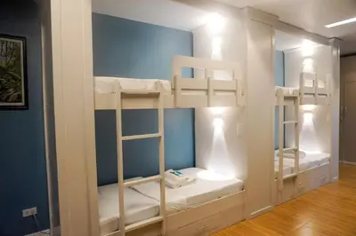 a room with three bunk beds in a room at ALTEAN Apartments - Lydia Room in Manila