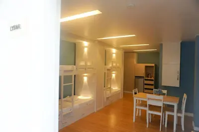 a dining room with a table and a room with a kitchen at ALTEAN Apartments - Lydia Room in Manila