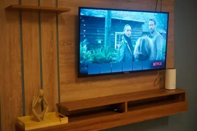 a flat screen tv sitting on a wooden entertainment center at ALTEAN Apartments - Lydia Room in Manila