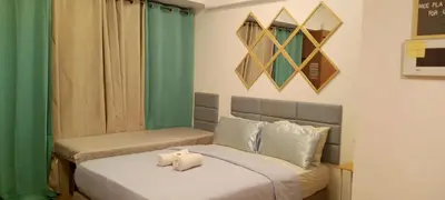 a bedroom with two beds with towels on them at Avah de lara condotel NAIA T3 in Manila