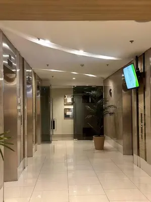 a hallway in a building with a tv on the ceiling at Pasay City MOA, Pearl Suite in Shell Residences in Manila