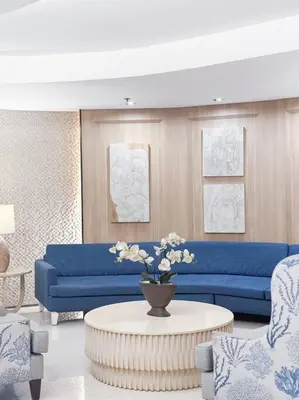 a living room with a blue couch and a table at Pasay City MOA, Pearl Suite in Shell Residences in Manila
