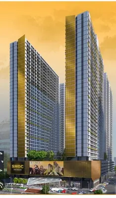 three tall skyscrapers in a city with a parking lot at SMDC Fame Residence luxurious family suite condo near mrt in Manila