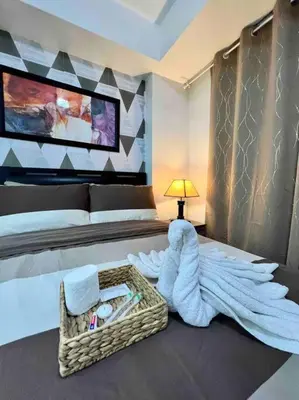 a bedroom with a bed with a wicker basket on the floor at Azure cozy corners in Manila