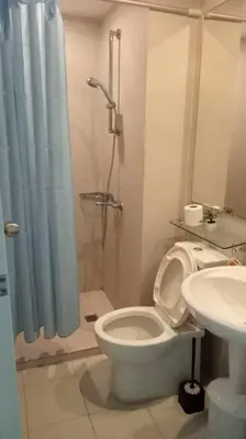 a bathroom with a shower and a toilet and a sink at Azure Urban Resort a12 Wavepool near mall airport in Manila