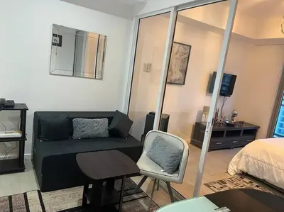 a room with a couch and a bed and a chair at Azure Urban Resort a12 Wavepool near mall airport in Manila