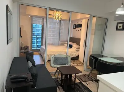 a living room with a couch and a bedroom at Azure Urban Resort a12 Wavepool near mall airport in Manila