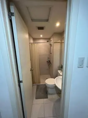 a small bathroom with a toilet and a shower at Azure Urban Resort a12 Wavepool near mall airport in Manila