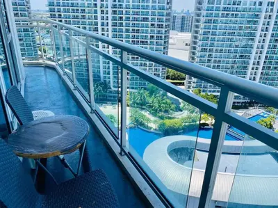 a balcony with a view of a swimming pool on a building at Azure Urban Resort a13 near airport wavepool in Manila