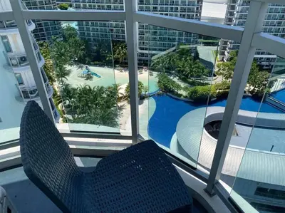 a balcony with a view of a pool and a resort at Azure Urban Resort a13 near airport wavepool in Manila